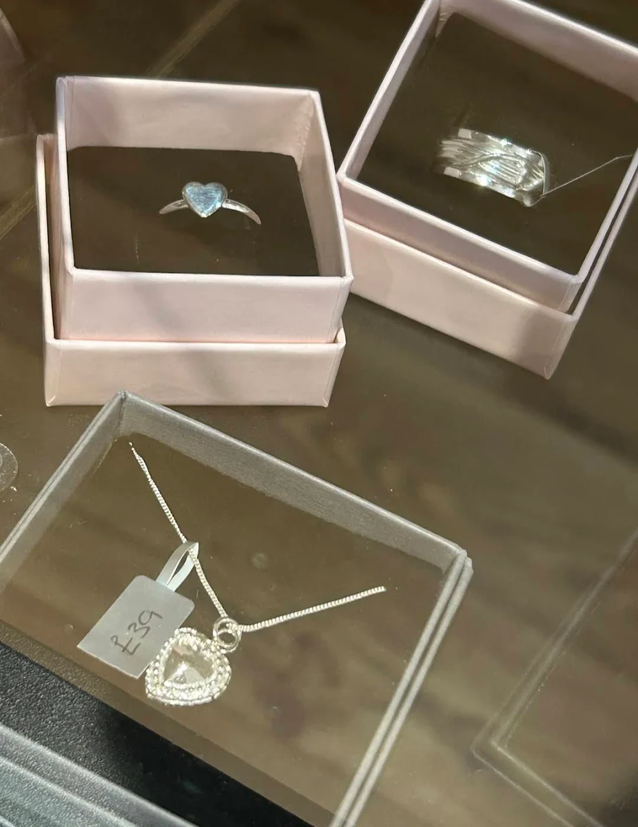 Silver rings and a heart pendant necklace in gift boxes