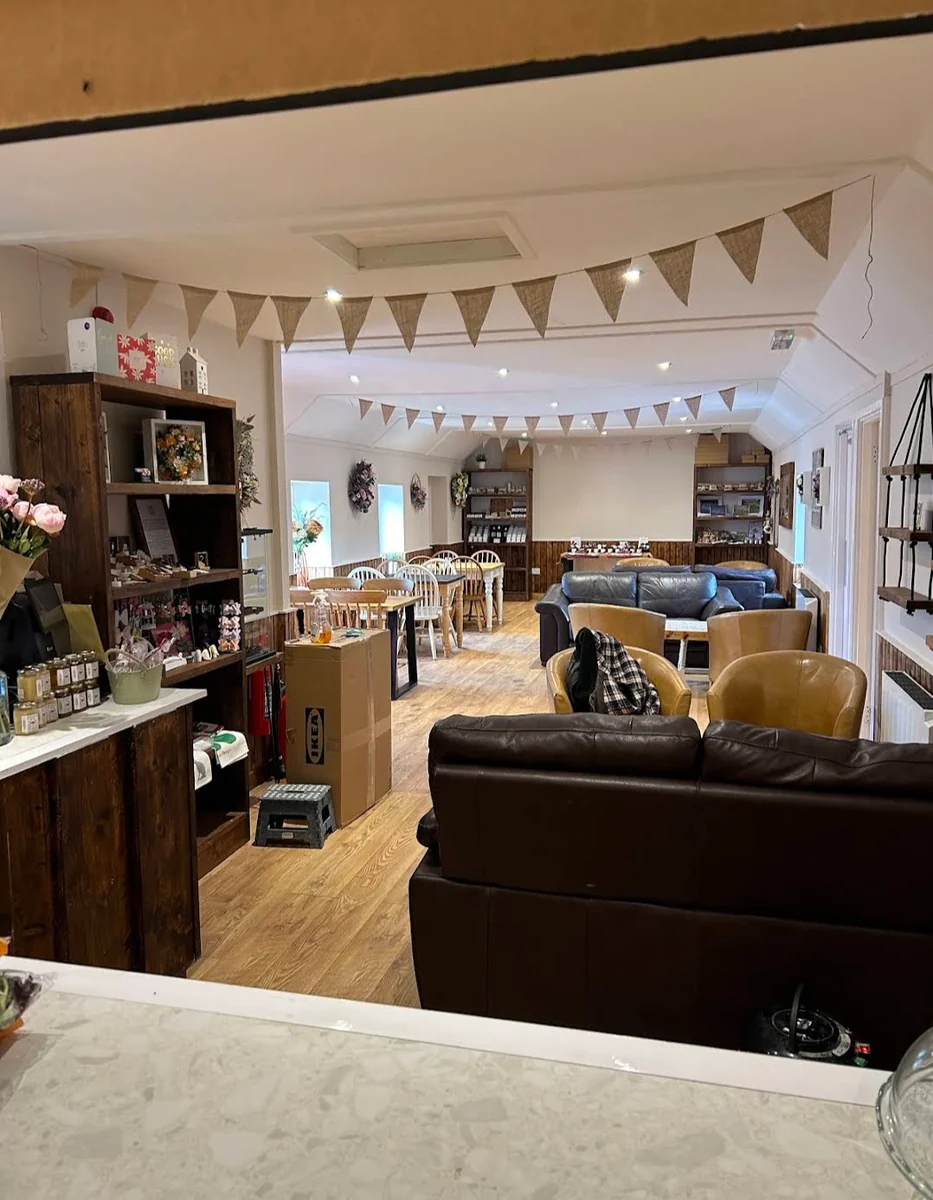 Inside the bistro: bunting, leather sofas and tables set with fresh flowers
