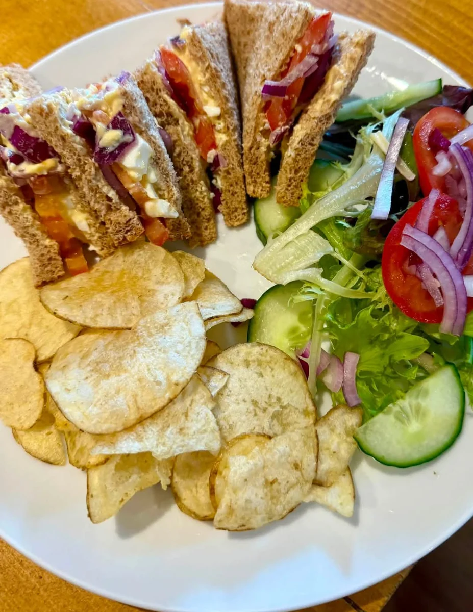 A freshly made sandwich served with side salad and crisps at Chic Rustic Bistro