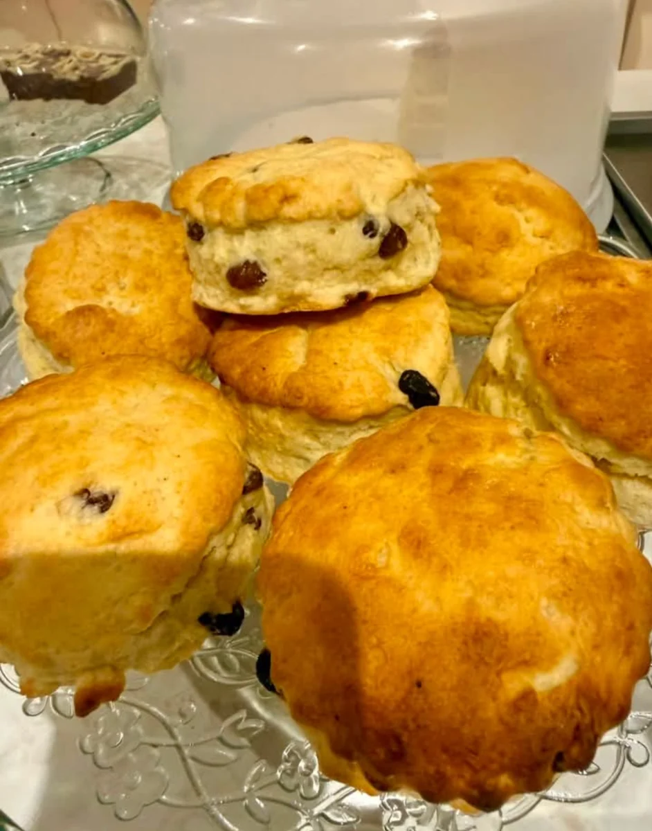 Homemade fruit scones on a glass cake stand